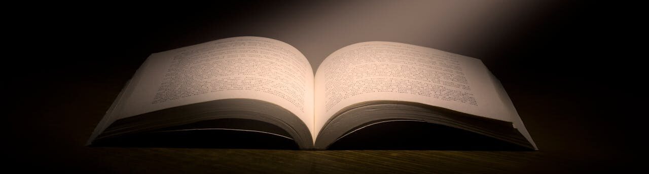 A captivating image of an open book under a dramatic spotlight, symbolizing knowledge.